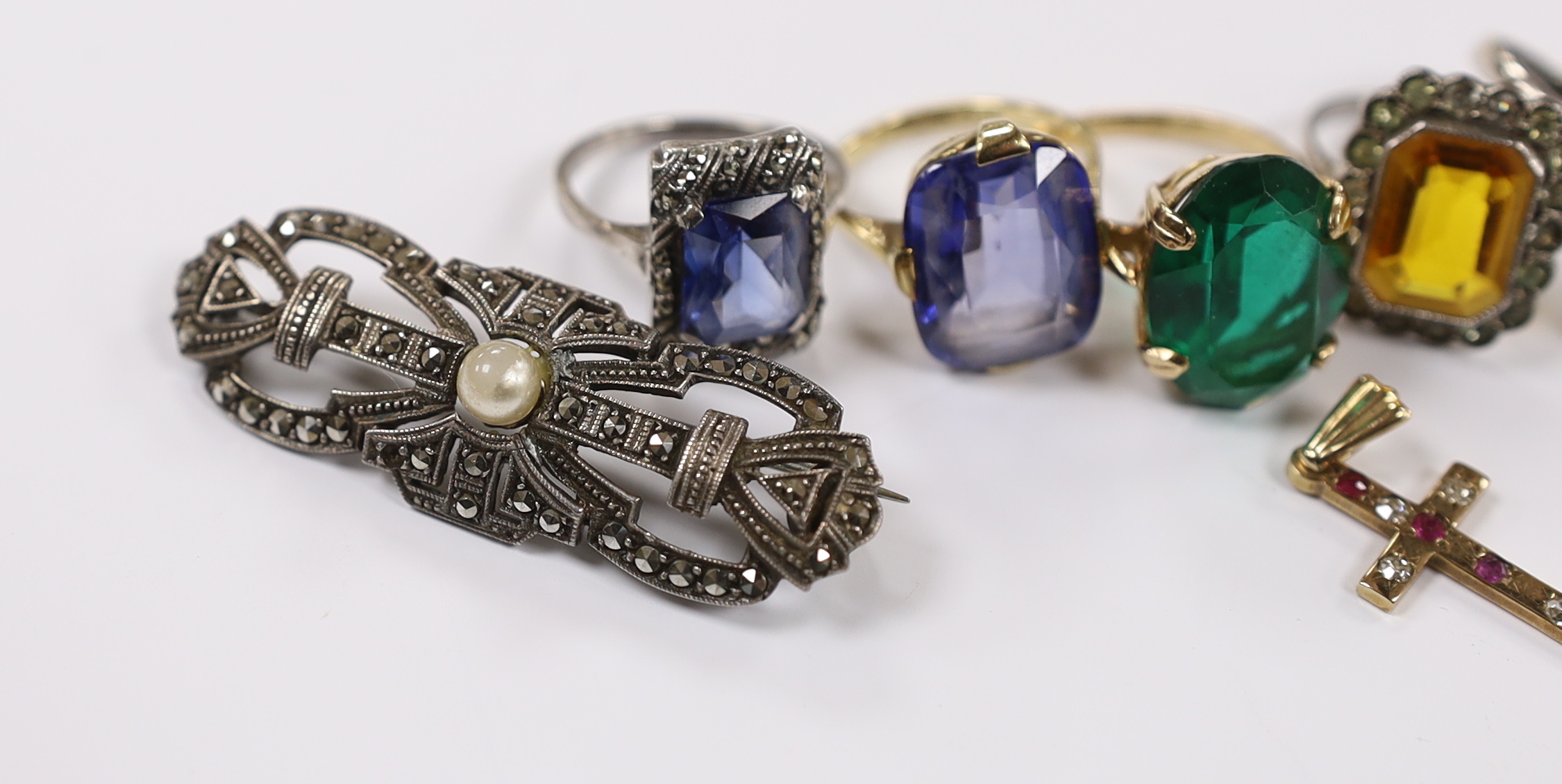 A 9ct and single stone rectangular cushion cut synthetic sapphire set ring, a 9ct gold and gem set cross pendant and a small group of early to mid 20th century jewellery including marcasite and paste set.